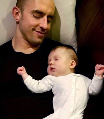 Man with his baby sleeping on his chest