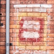 An image of a brick wall with an oven built into it.