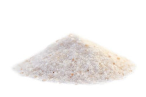 An image of a pile of pink salt on a white background.