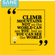 An image of a sign that reads climb mountain not so the world can see you but so you can see the world.