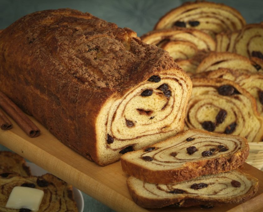 An image of a loaf of raisin bread with slices.