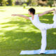 An image of an attractive middle aged woman doing yoga outdoors.