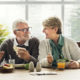 An image of a senior male and female couple eating at the dining room table.