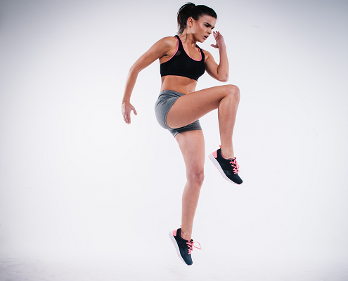An image of a young, fit woman doing lunges. 