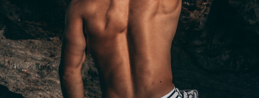 An image of a muscular young man's back.