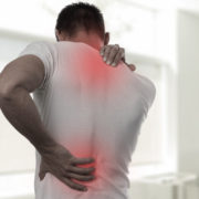 An image of man's back with the upper and lower part highlighted in red signifying pain.