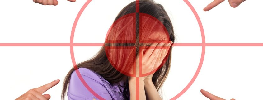 An image of an upset women in firearms crosshairs with fingers pointing at her.