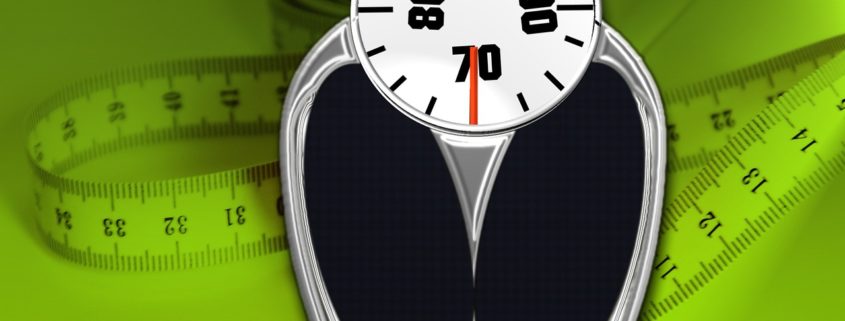 A cartoon image of a bathroom scale and a measuring tape on a green background.