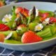 An image of a bowl of asparagus salad with strawberries.