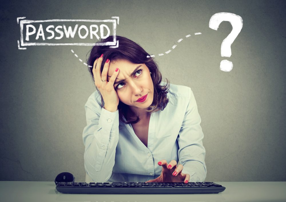 An image of a puzzled woman, fingers above computer keyword, with text that reads, password, and a question mark beside it. 