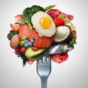 A 3d image of fish, nuts, meat, eggs, and other healthy foods on a fork.