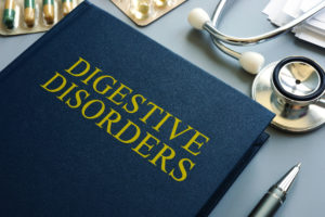 An image of a book about digestive disorders and a stethoscope.